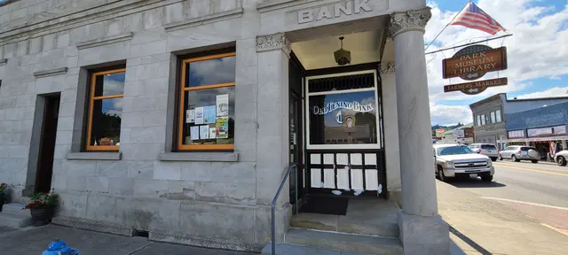 Historic stone bank building entrance with American flag after repaint